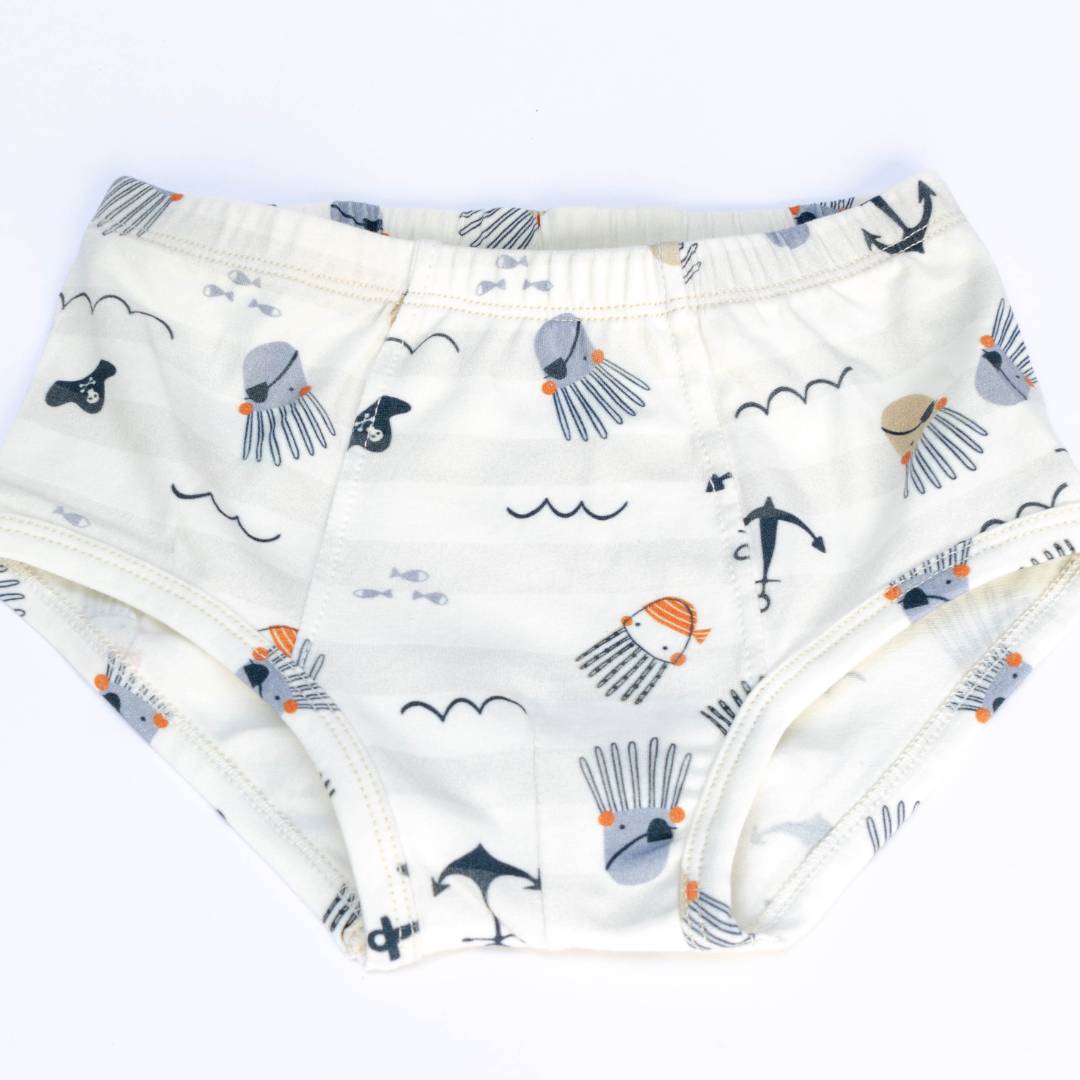 A set of two organic cotton underwear for boys featuring whimsical ocean-themed prints of playful crabs and a fearless pirate octopus.