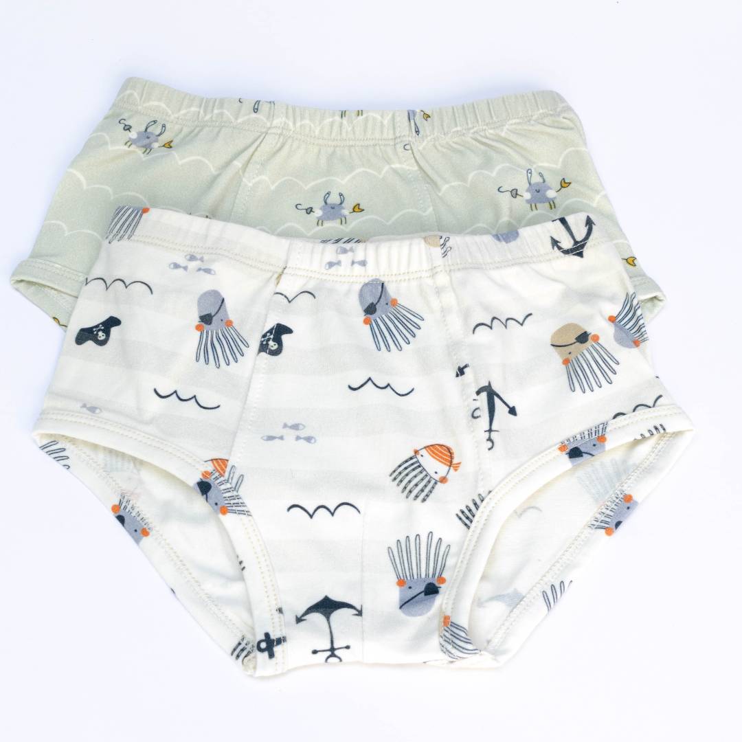 A set of two organic cotton underwear for boys featuring whimsical ocean-themed prints of playful crabs and a fearless pirate octopus.