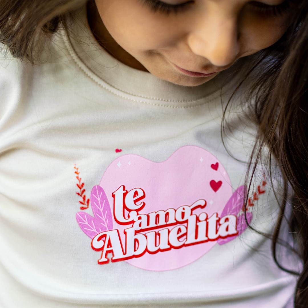 TE AMO ABUELITA ORGANIC GRAPHIC TEE. Crafted from the finest GOTS-certified organic natural colored Pima cotton from Peru, this tee is as gentle on your child's skin as it is on the environment. The soft, breathable fabric